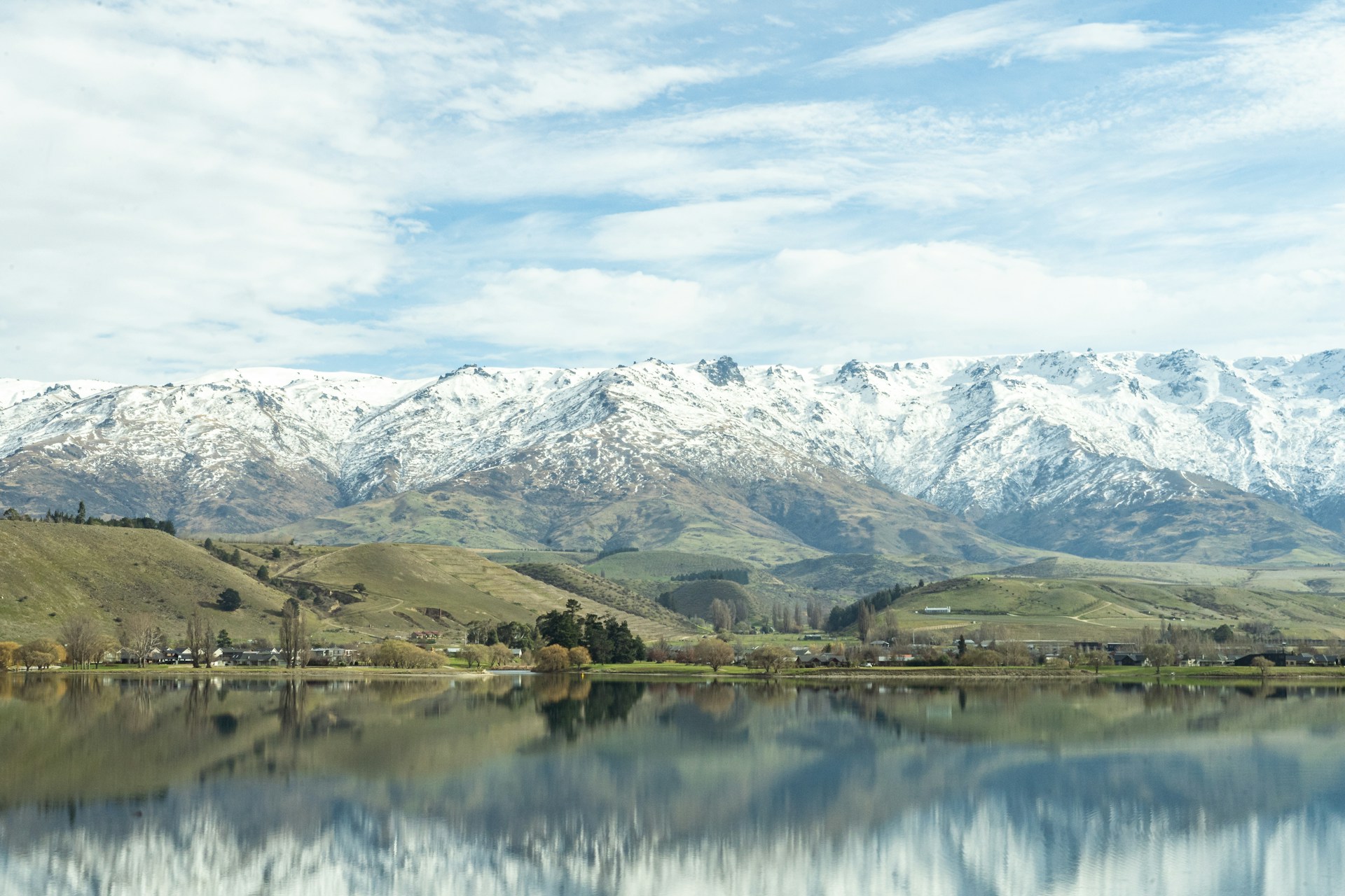 Snow-covered Pisa Range reflected in Lake Dunstan, Central Otago